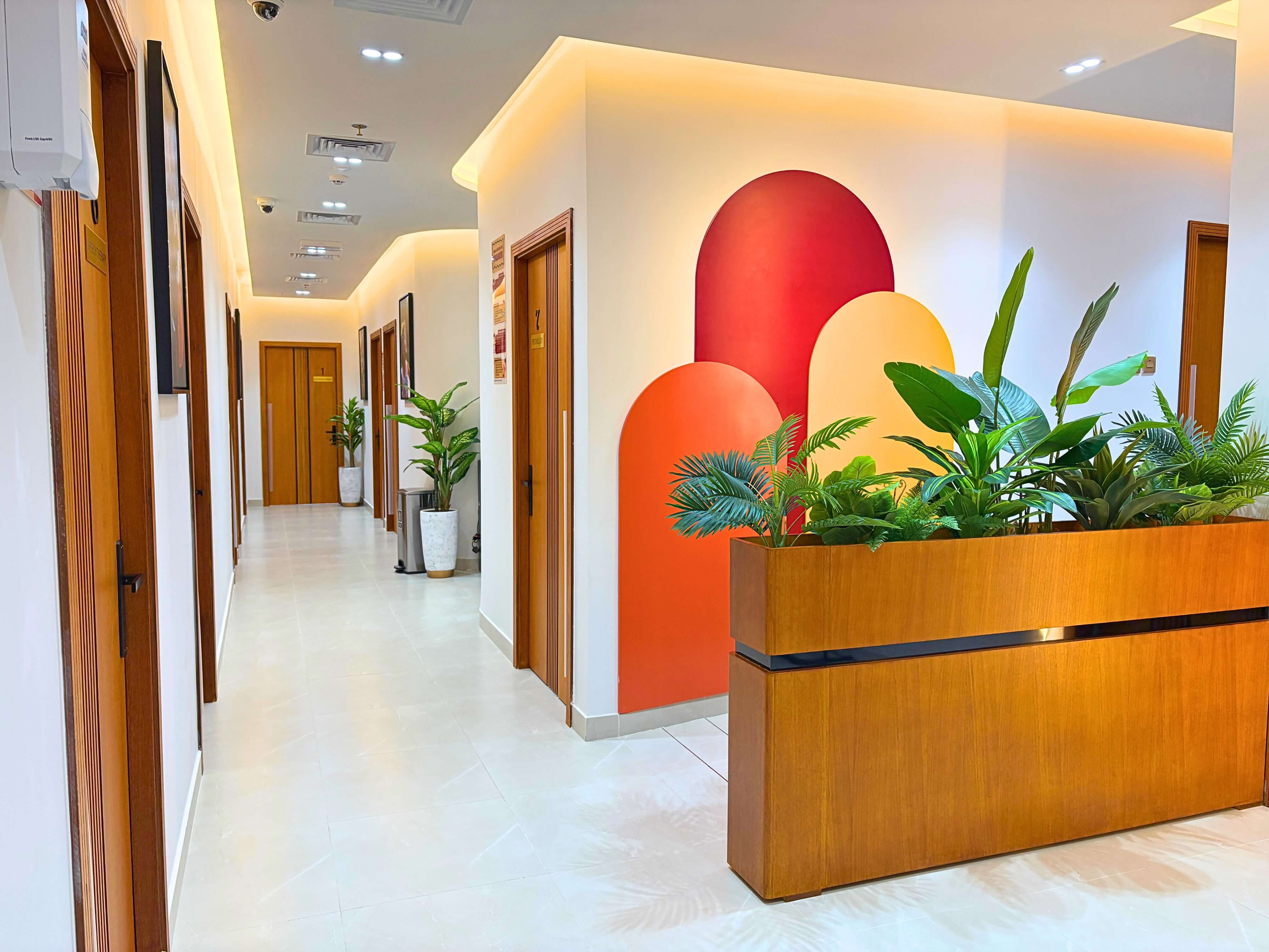 Warm clinic corridor leading to feeding-therapy rooms at Bridges Care Speech Therapy Center